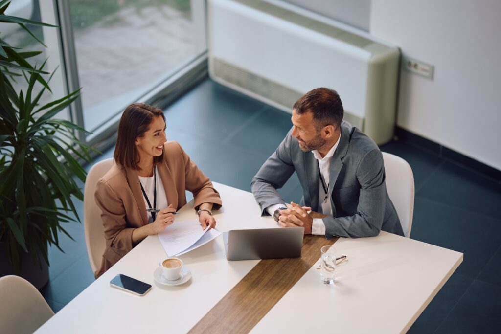 Young direct sales professional being mentored by a senior executive