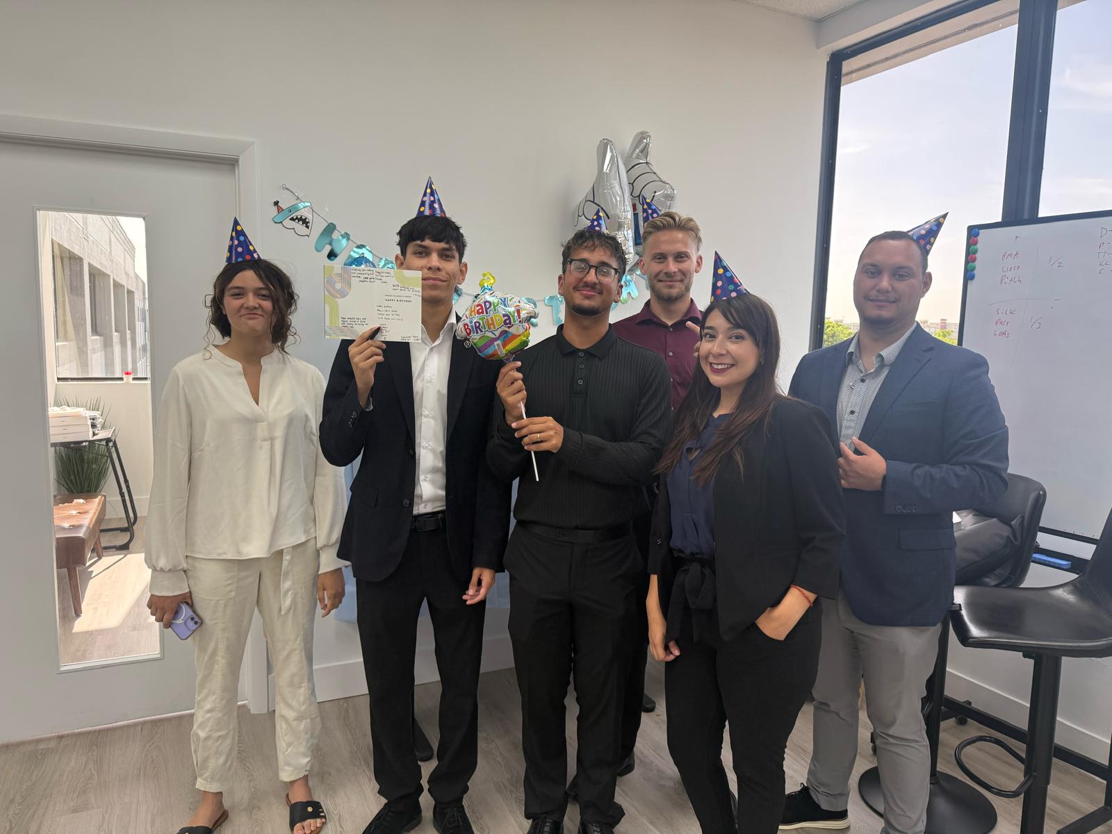 Profits Management team celebrating a team member’s birthday in the office.