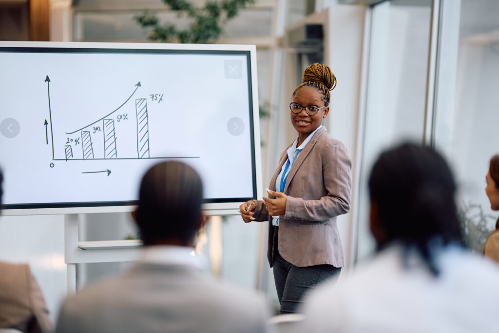 A young professional giving a presentation in front of her colleagues
